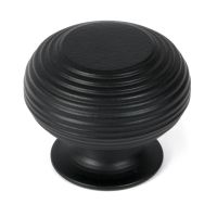 The 40mm "Garrison" Ribbed Beehive Knob in Matt Black on a White Background Shown Stood Upright 