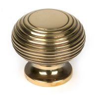 The 40mm Individual Aged Brass Beehive Cabinet Knob on a White Background Shown Upright