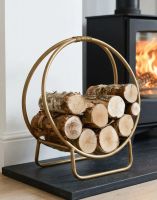 The 45cm Gold Circular Log Rack & Holder next to a Log Burner Stove in a Modern Home - Digital Illustration The 45cm Gold Circular Log Rack & Holder next to a Log Burner Stove in a Modern Home - Digital Illustration