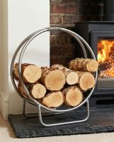 The 45cm Pewter Finish Contemporary Circular Log Rack & Holder on a Black Stone Hearth in a Modern Home - Digital Illustration The 45cm Pewter Finish Contemporary Circular Log Rack & Holder on a Black Stone Hearth in a Modern Home - Digital Illustration