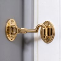 The 4 Inch Brass Cabin Hook Silent Type Heavy Shown Being Used to Hold Open a Door - Digital Illustration 