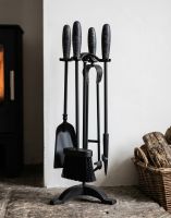 The 54m Matte Black & Gunmetal Effect Classical Four Tool Companion Set next to a Log Basket on a Fireplace - Digital Illustration 