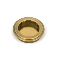 The 60mm Art Deco Round Flush Pull Handle in Aged Brass Shown from the Front on a White Background
