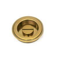 The 60mm Art Deco Round Sliding Pocket Door Privacy Set in Aged Brass Showing the Coin Release Side