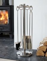 The 62cm “Westgate Park” Polished Chrome Companion Set with a Log Burner Stove in the Background in a Modern Home Interior - Digital Illustration