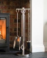 The 62cm “Westgate Park” Polished Chrome Companion Set with a Log Burner Stove in the Background in a Modern Home Interior - Digital Illustration