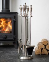 The 64cm Matte Pewter Companion Set With Urn Handles on a Black Stone Hearth next to a Log Burner Stove - Digital Illustration The 64cm Matte Pewter Companion Set With Urn Handles on a Black Stone Hearth next to a Log Burner Stove - Digital Illustration