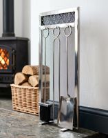 The 66cm “Highburn House” Stainless Steel Companion Set next to a Log Basket in a White Cottage Fireplace - Digital Illustration 
