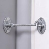 The 6 Inch "Masio" Galvanised Cabin Hook Shown From the Side Holding Open a Door - Digital Illustration