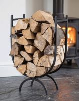 The 70cm Black Wrought Iron Curved Log Holder with Split Logs next to a Traditional Burner Stove - Digital Illustration