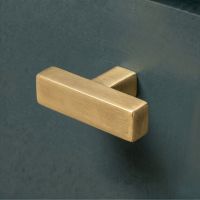 The Aged Brass "Kodiak" Heavyweight Block T-Bar Cabinet Handle Mounted on a Dark Blue Kitchen Cupboard Drawer - Digital Illustration The Aged Brass "Kodiak" Heavyweight Block T-Bar Cabinet Handle Mounted on a Dark Blue Kitchen Cupboard Drawer - Digital Illustration