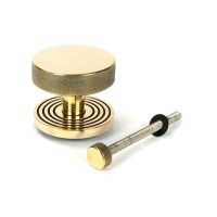 The Aged Brass Knurled Centre Door Knob on Beehive Rose with Bolt Fitting on a White Background The Aged Brass Knurled Centre Door Knob on Beehive Rose with Bolt Fitting on a White Background