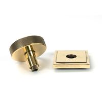 The Aged Brass Knurled Centre Door Knob on Square Rose Displayed in Separate Sections The Aged Brass Knurled Centre Door Knob on Square Rose Displayed in Separate Sections