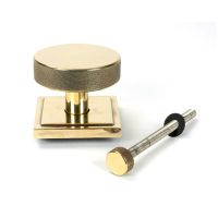 The Aged Brass Knurled Centre Door Knob on Square Rose with Bolt Fitting on a White Background The Aged Brass Knurled Centre Door Knob on Square Rose with Bolt Fitting on a White Background