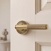 The Aged Brass Knurled Lever on Beehive Rose Set Fitted onto a Cream Door in a Modern Home - Digital Illustration 