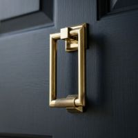 The Aged Brass Modern Knurled Rectangular Door Knocker on a Blue Door on a Modern Property - Digital Illustration