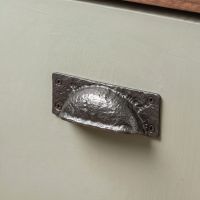 The Antique Black Iron Hooded Cabinet Or Drawer Pull Handle Fitted on a Wooden Kitchen Drawer in a Traditional Cottage - Digital Illustration