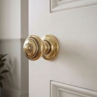 The Antique Brass Concealed Mortice Door Knob Set on a White Coloured Door in a Modern Home Interior - Digital Illustration The Antique Brass Concealed Mortice Door Knob Set on a White Coloured Door in a Modern Home Interior - Digital Illustration