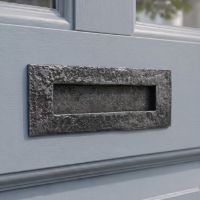 The Antique Iron Letter Plate on a Light Grey Front Door on a Period Property - Digital Illustration