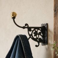 The Antonietta Double Hook in an Entrance Hallway Shown Close up with a Coat Hung on it - Digital Illustration 