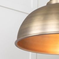 The Arcus Spun Pendant Light in Aged Brass Shown Lit up Showing a Close up of the Light Shade
