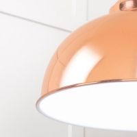 The Arcus Spun Pendant Light in Copper and Glossy White Shown Lit From a Low Angle