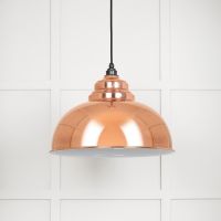 The Arcus Spun Pendant Light in Copper and Glossy White Shown on a White Panelled Background