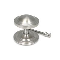 The Art Deco Stepped Rose Center Door Knob in Satin Stainless Steel Shown next to Fitting Bolt