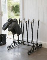 The Athleshaw Black 5 Pair Boot and Welly Rack on a Classic Stone Tiled Floor Next to a Kitchen Back Door - Digital Illustration The Athleshaw Black 5 Pair Boot and Welly Rack on a Classic Stone Tiled Floor Next to a Kitchen Back Door - Digital Illustration