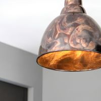 The Aura Dome Pendant Light in Burnished Brass Shown Lit up and Close up