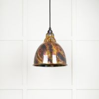 The Aura Dome Pendant Light in Burnished Brass Shown with the Light off on a White Panelled Background