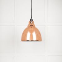The Aura Dome Pendant Light in Copper and White Gloss Shown with the Light off on a White Panelled Background