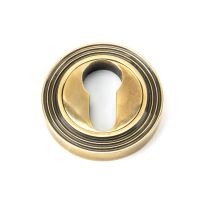 The Beehive Concealed Standard Euro Escutcheon - Aged Brass on a White Background 