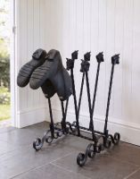 The Black Aintree Four-Pair Boot and Welly Rack Placed in a Contemporary Stone Tiled Porch - Digital Illustration 