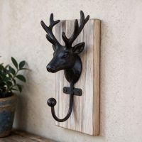 The Black and Natural Wood Stag Coat Hook Mounted on a Textured Wall in a Modern Interior Setting - Digital Illustration The Black and Natural Wood Stag Coat Hook Mounted on a Textured Wall in a Modern Interior Setting - Digital Illustration