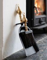 The Black and Polished Brass Pan and Brush Set next to a Traditional Cottage Fireplace - Digital Illustration The Black and Polished Brass Pan and Brush Set next to a Traditional Cottage Fireplace - Digital Illustration