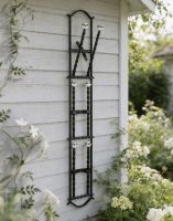 The Black Chattlehurst 3 Pair Wall Mounted Boot Rack Mounted on a Wooden Exterior Wall - Digital Illustration 