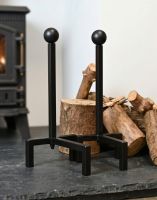The Black Contemporary Steel Fire Dogs on a Stone Hearth next to a Traditional Fireplace - Digital Illustration