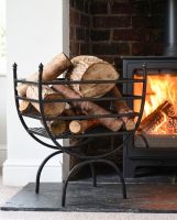 The Black Curved Iron Log Rack & Holder next to a White Fireplace with a Wood Burner Stove - Digital Illustration 
