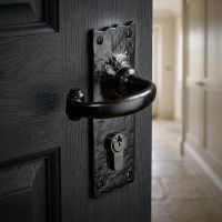 The Black Euro Cylinder Scalloped Lever Door Handle in a Cottage Stone Floor Hallway - Digital Illustration 