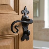 The Black Fleur-de-Lis Monkey Tail Bathroom Door Handle on a Brown Bathroom Door - Digital Illustration 