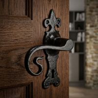 The Black Fleur-de-Lis Monkey Tail Keyhole Lock Handle on a Dark Wooden Door Leading to a Modern Cottage Interior - Digital Illustration