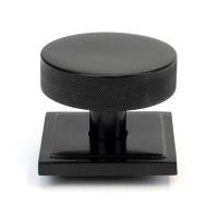 The Black Knurled Centre Door Knob on a Square Rose Shown Upright on a White Background The Black Knurled Centre Door Knob on a Square Rose Shown Upright on a White Background