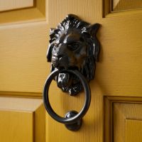 The Black Lions Head Door Knocker on a Bright Yellow Door on a Period Property - Digital Illustration
