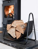 The Black Steel & Black Leather Log Holder in a Modern Home Interior next to a Log Burner Stove - Digital Illustration The Black Steel & Black Leather Log Holder in a Modern Home Interior next to a Log Burner Stove - Digital Illustration
