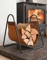 The Black Steel & Brown Leather Log Holder in a Modern Home next to a Log Burner Stove - Digital Illustration The Black Steel & Brown Leather Log Holder in a Modern Home next to a Log Burner Stove - Digital Illustration