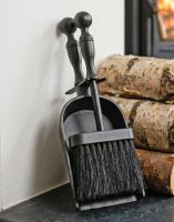 The Black Traditional Pan and Brush Set next to a Pile of Logs by a Log Burner Stove - Digital Illustration