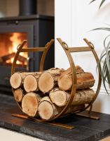 The Blacksmith Brass Finish Curved Log Rack next to a Country Cottage Fire place - Digital Illustration