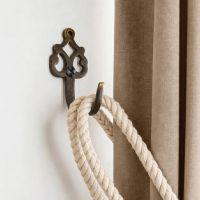The ’Blaneau’ Curtain tie back Mounted on a Modern White Interior Home wall - Digital Illustration