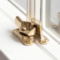 The Brass Fitch Sash Window Fastener Shown Fitted on a Classic White Home Window - Digital Illustration The Brass Fitch Sash Window Fastener Shown Fitted on a Classic White Home Window - Digital Illustration